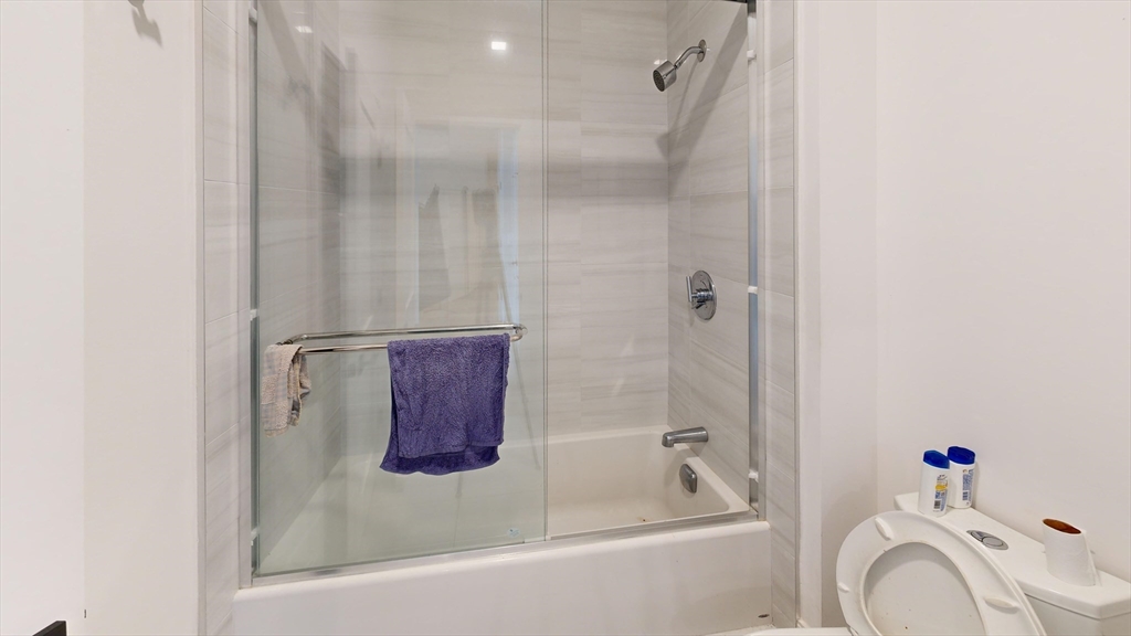 157 Everett Street, Unit 202 Boston, MA 02134 - Photo 5 of 7 a bathroom with a bathtub and a shower