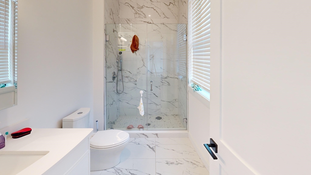 157 Everett Street, Unit 202 Boston, MA 02134 - Photo 6 of 7 a bathroom with a toilet and a shower