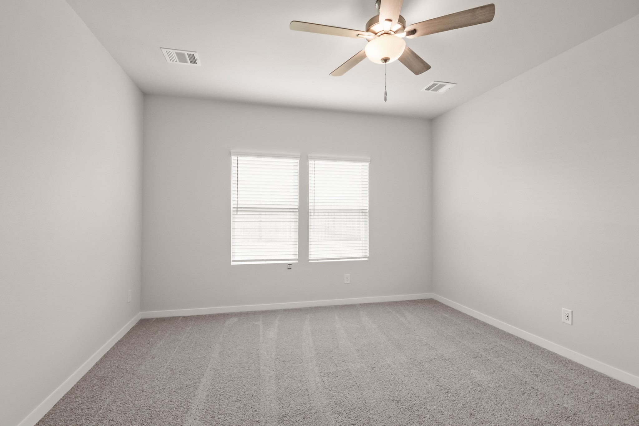 2138 Open Prairie Drive Texas City, TX 77568 - Photo 7 of 25 an empty room with a window and a fan