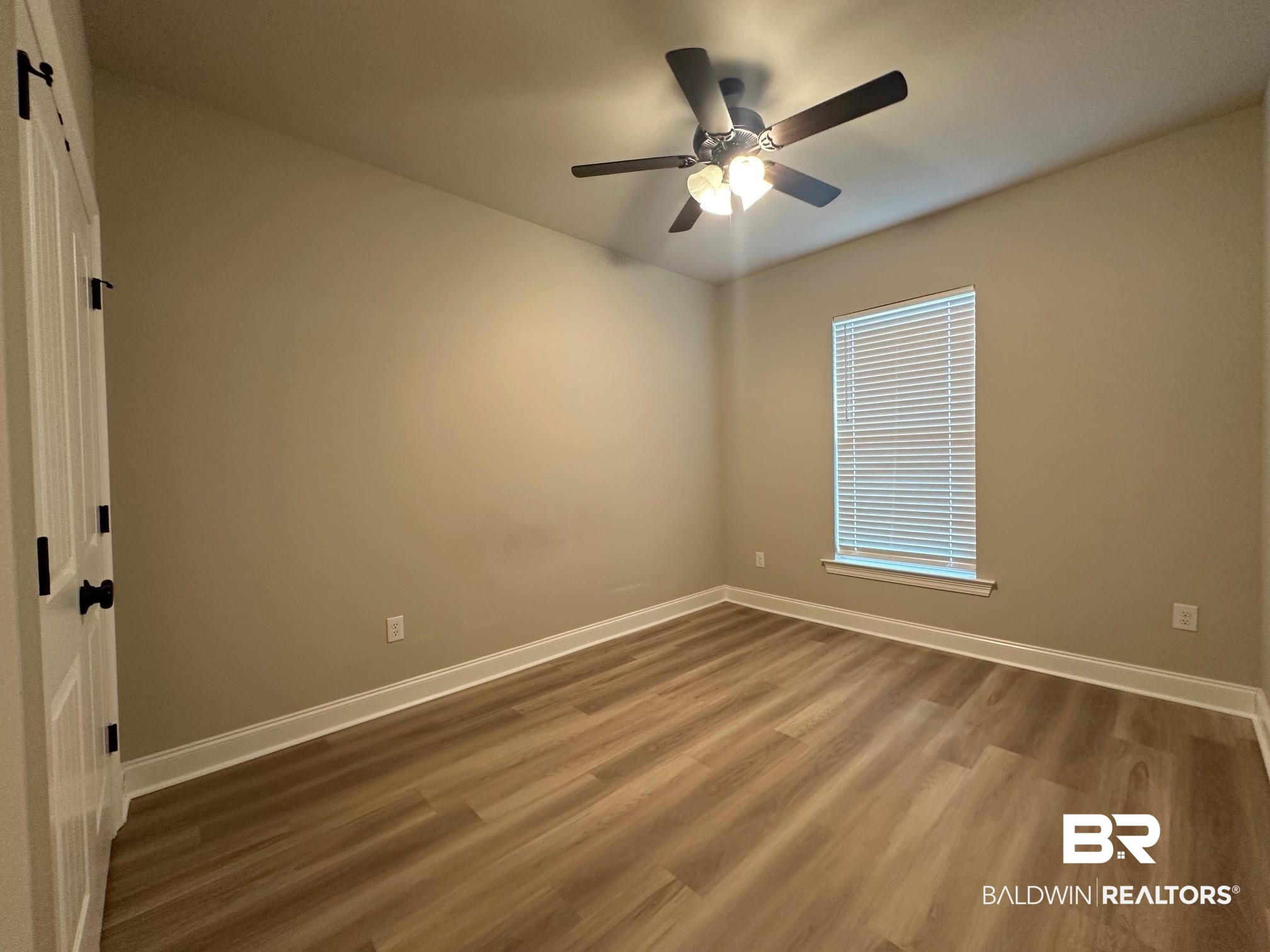 1009 Ruisseau Drive Foley, AL 36535 - Photo 48 of 55 Spare room featuring a wealth of natural light, wood-type flooring, and ceiling fan