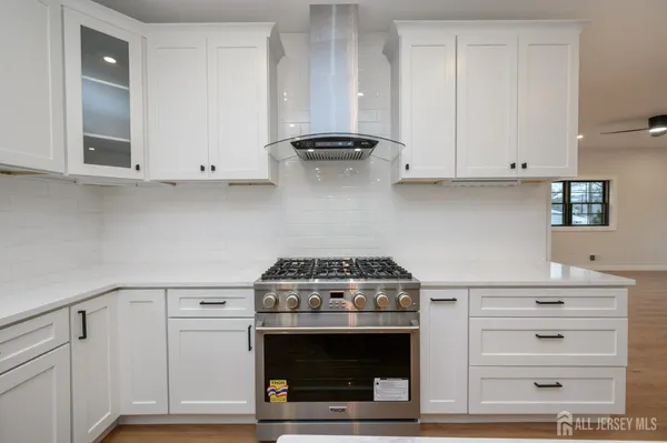 a view of a kitchen with a sink and a refrigerator
