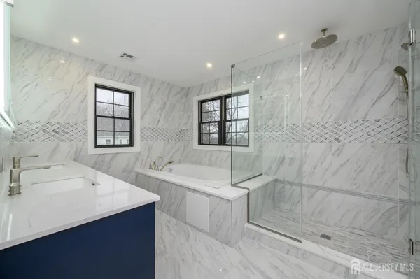 an empty room with wooden floor cabinet and windows