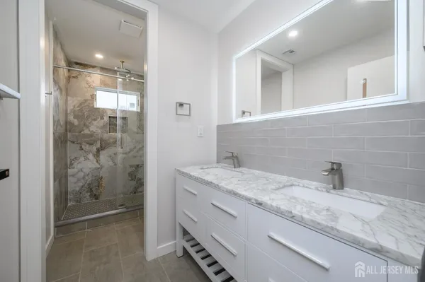 a bathroom with a shower and a bath tub