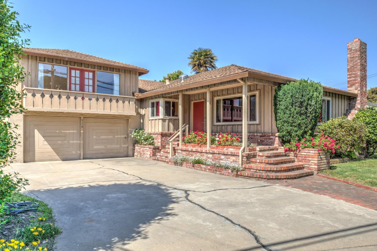 3240 Rio Road Carmel, CA 93923 - Photo 3 of 37 a front view of a house with a yard and outdoor seating