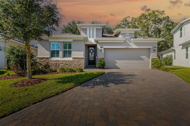 a front view of house with yard and trees