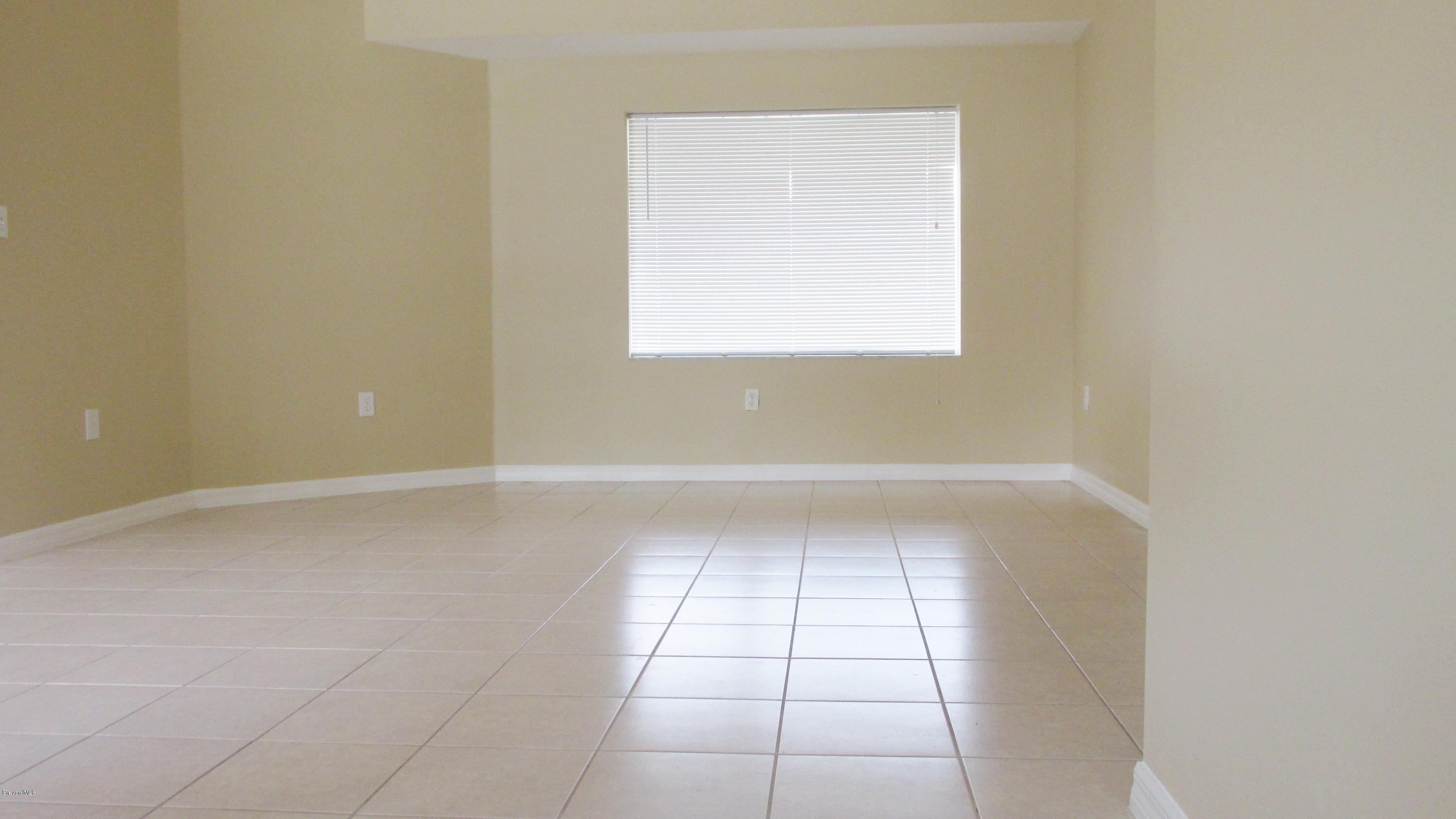 174 Tudor Road Southwest Palm Bay, FL 32908 - Photo 12 of 20 a view of an empty room with a window