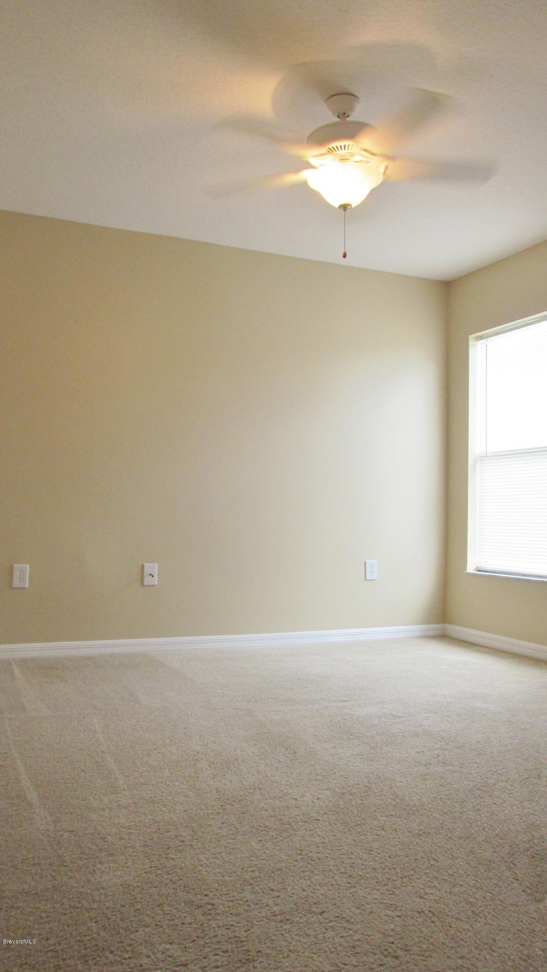 174 Tudor Road Southwest Palm Bay, FL 32908 - Photo 16 of 20 a view of an empty room with a window