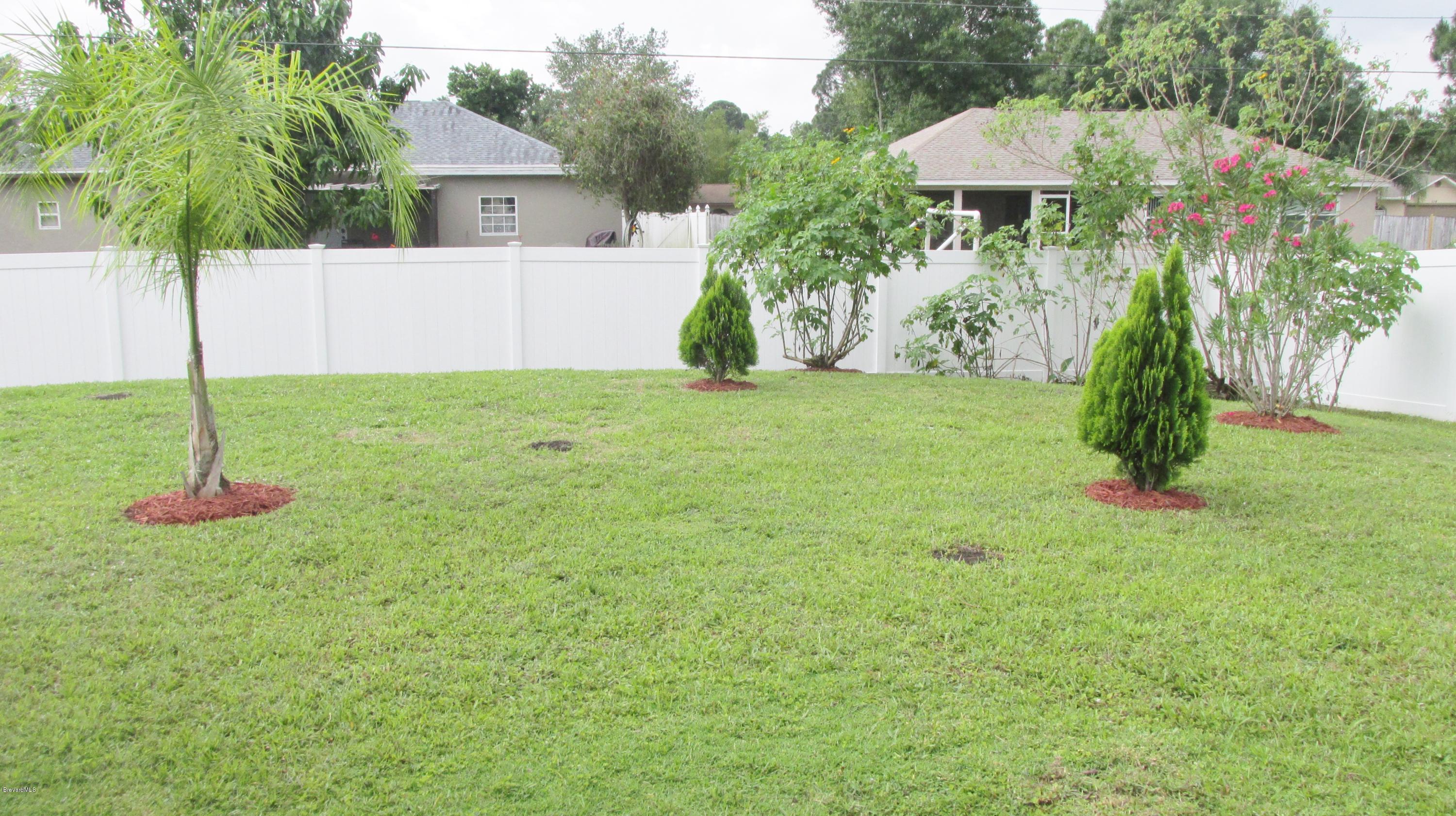 174 Tudor Road Southwest Palm Bay, FL 32908 - Photo 6 of 20 a front view of a house with a yard