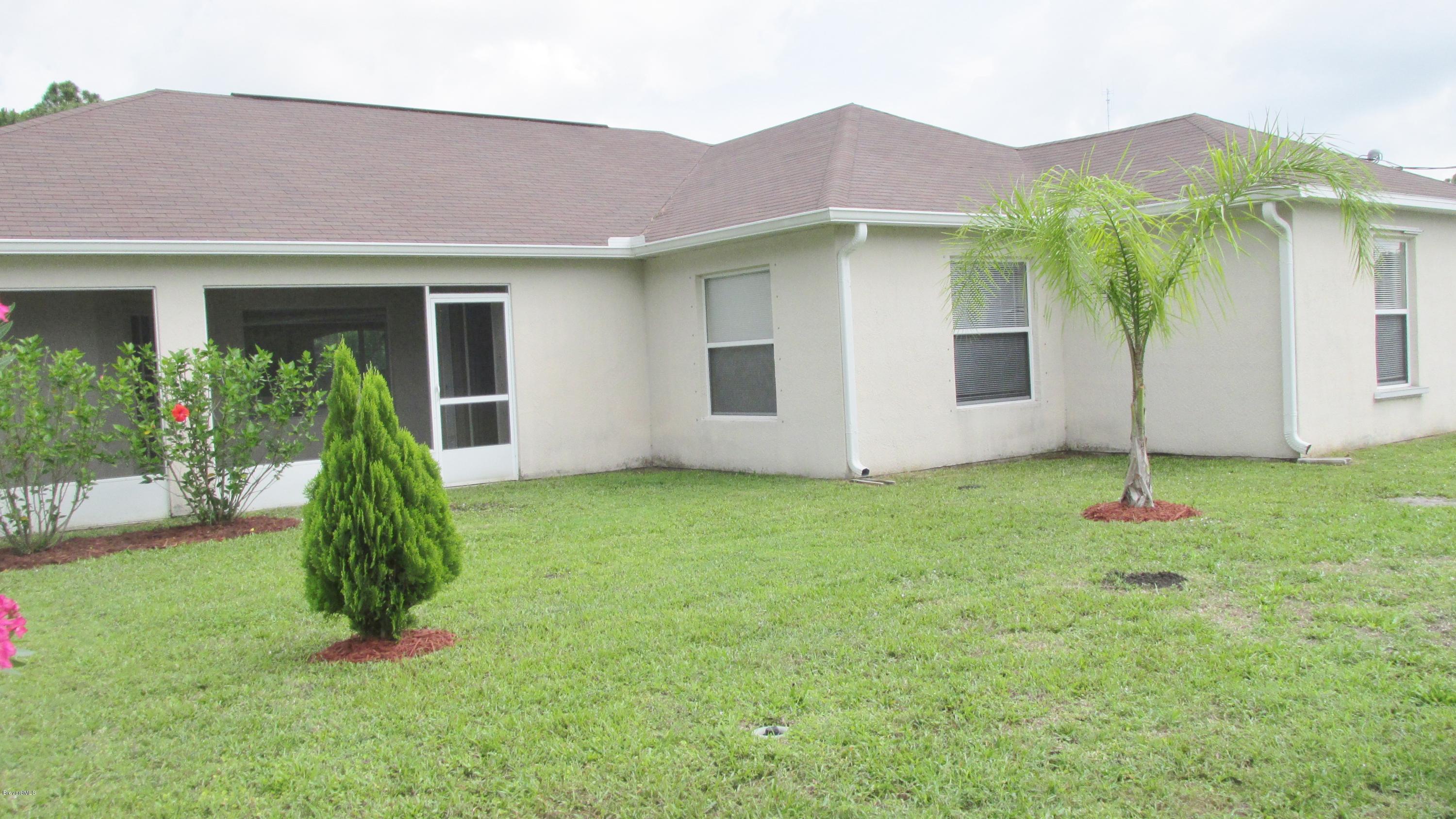 174 Tudor Road Southwest Palm Bay, FL 32908 - Photo 7 of 20 front view of a house with a yard