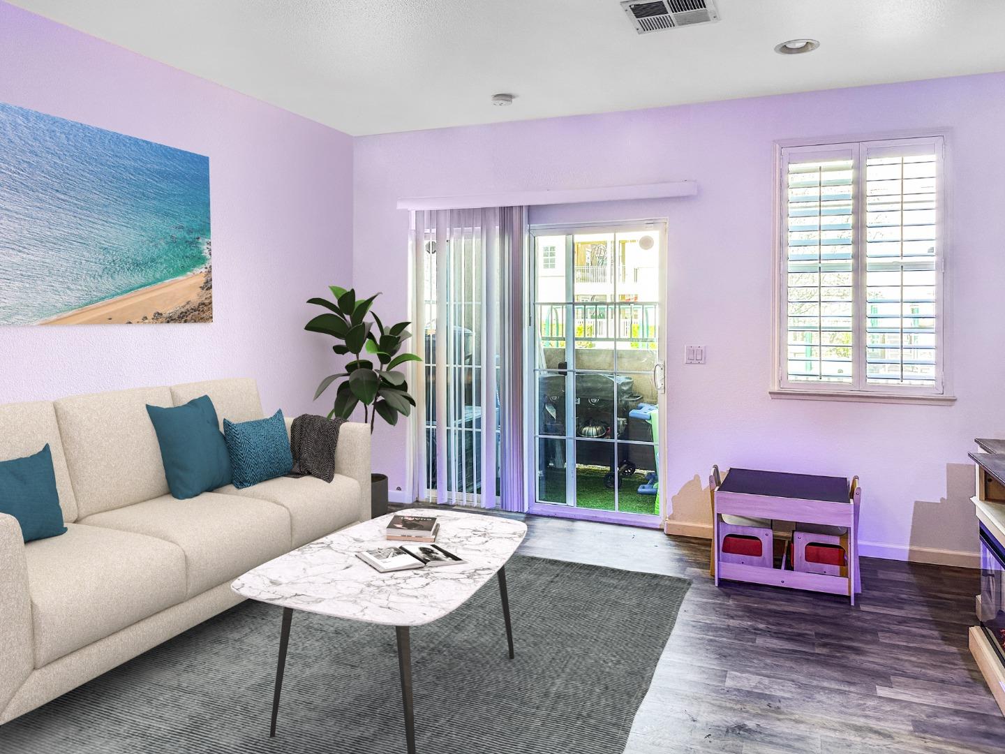 a living room with furniture and a potted plant