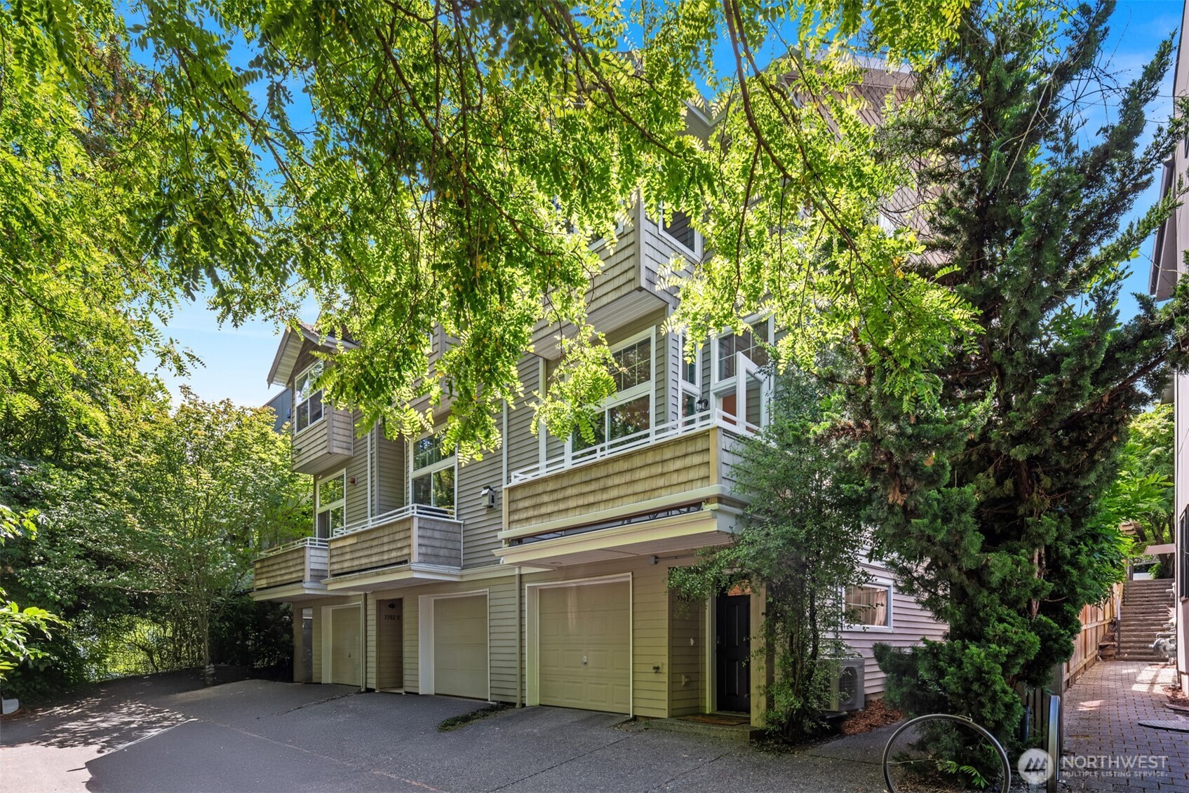 3302 West Government Way, Unit A Seattle, WA 98199 - Photo 2 of 32 a view of a house with a tree