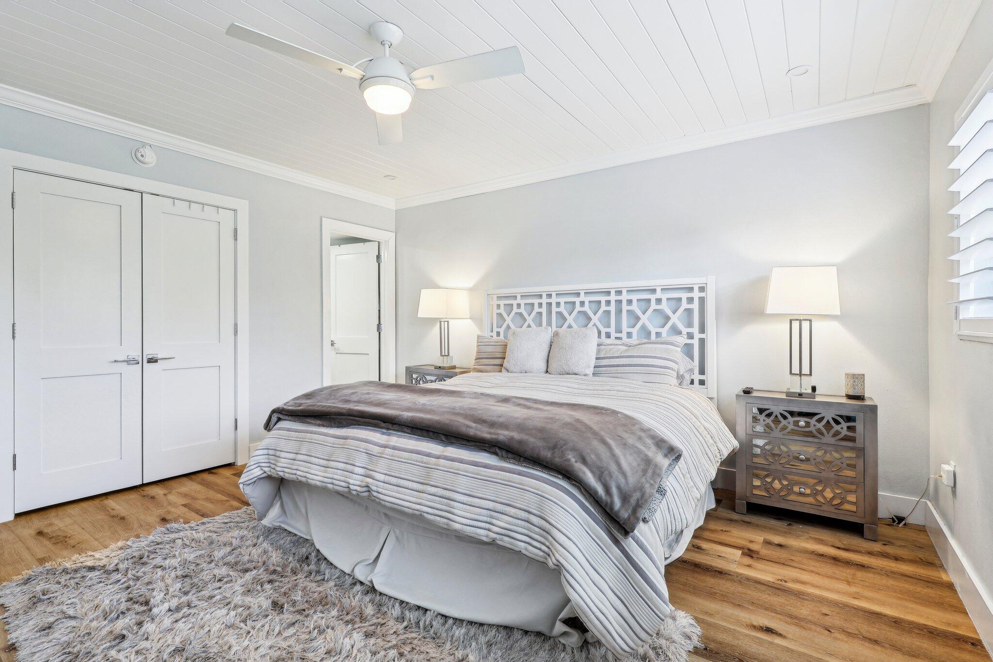 200 East Royal Palm Road, Unit 304 Boca Raton, FL 33432 - Photo 21 of 37 a bedroom with a bed and wooden floor