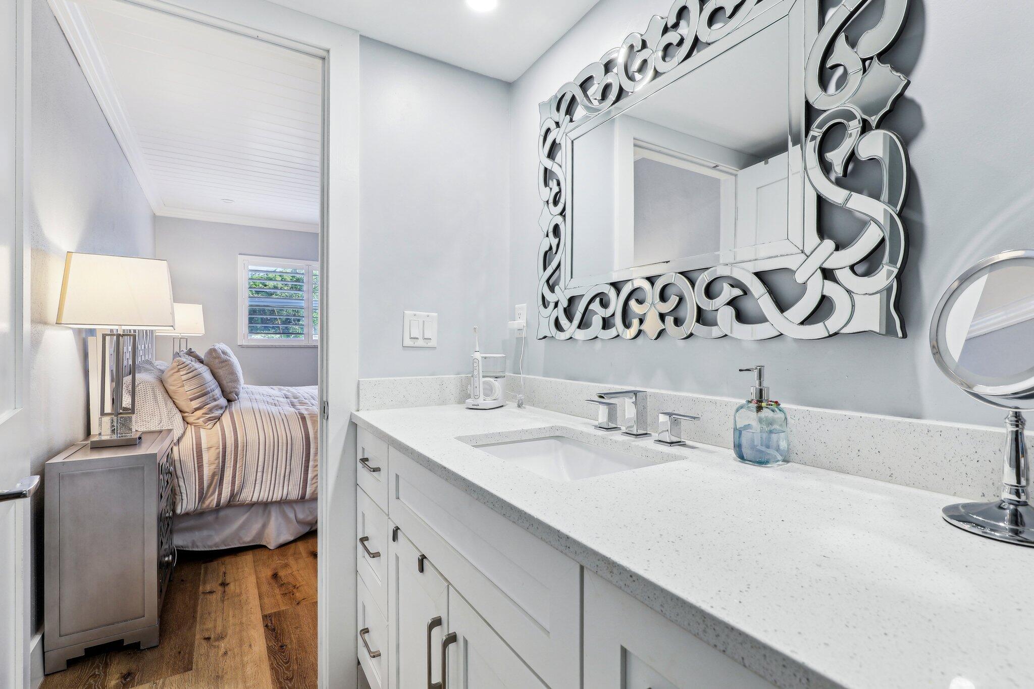 200 East Royal Palm Road, Unit 304 Boca Raton, FL 33432 - Photo 24 of 37 a en suite bathroom with a double vanity sink and a mirror