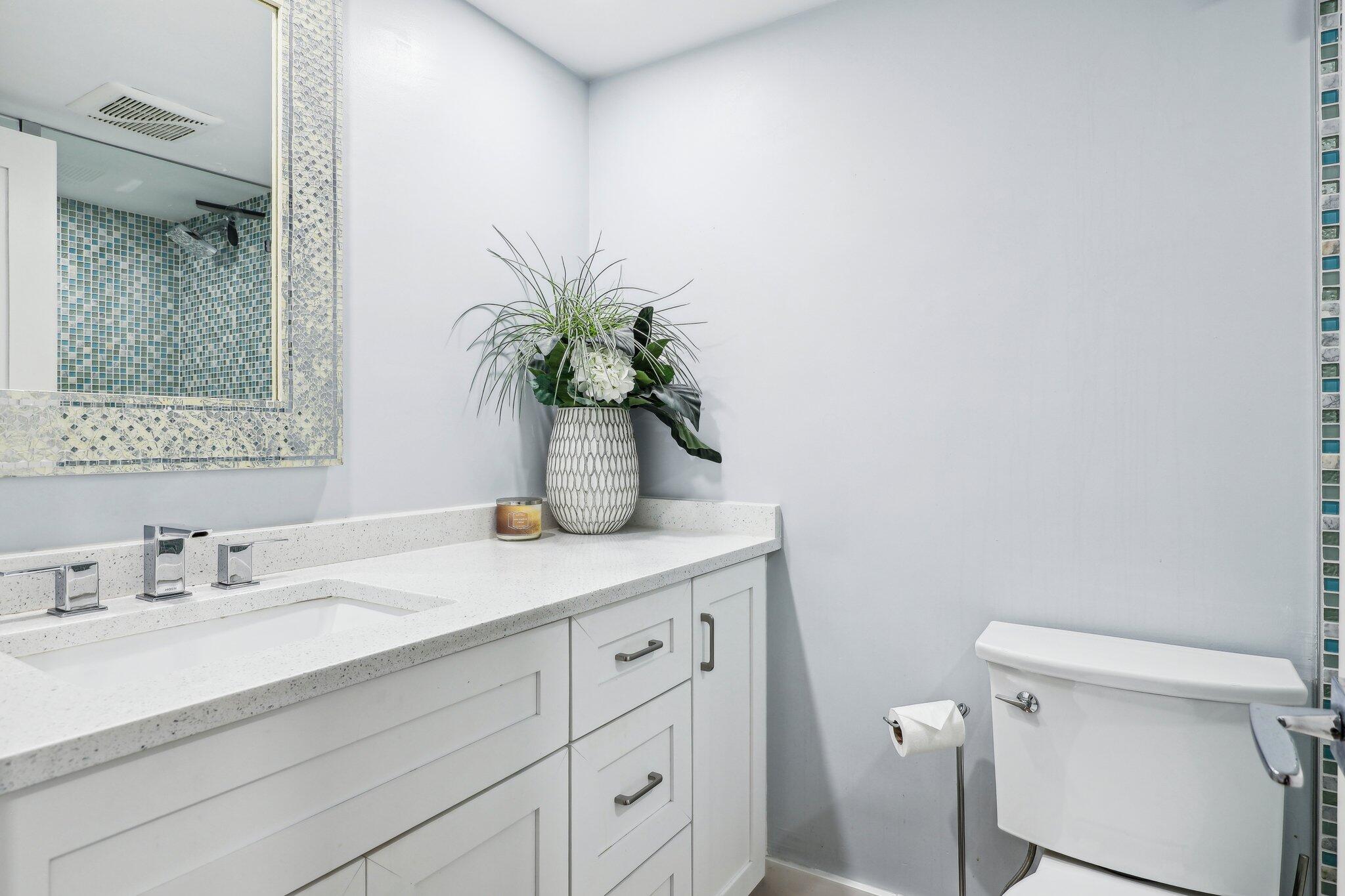 200 East Royal Palm Road, Unit 304 Boca Raton, FL 33432 - Photo 29 of 37 a bathroom with a granite countertop sink a toilet and a mirror