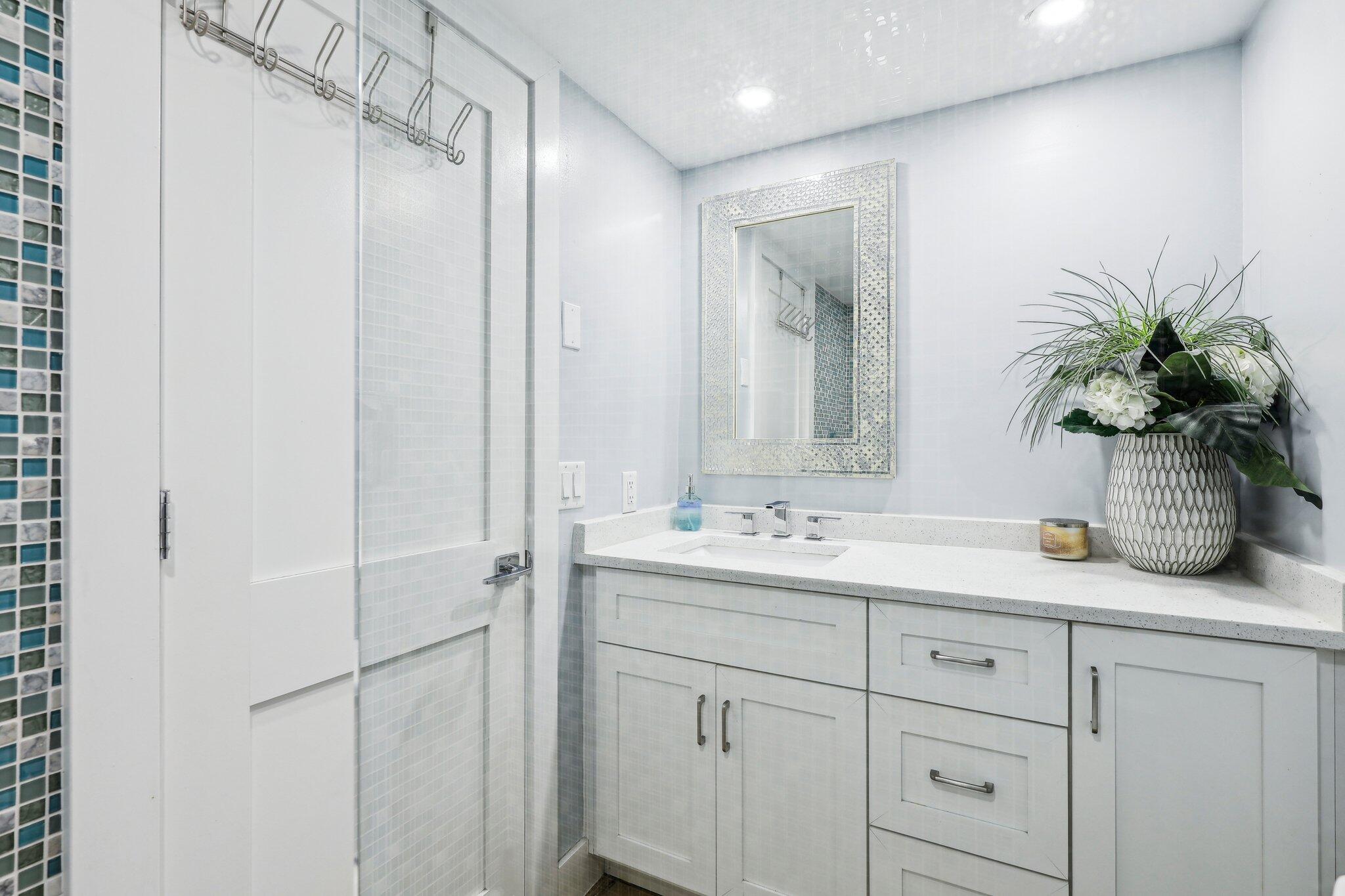 200 East Royal Palm Road, Unit 304 Boca Raton, FL 33432 - Photo 30 of 37 a bathroom with a granite countertop sink a mirror a vanity and shower