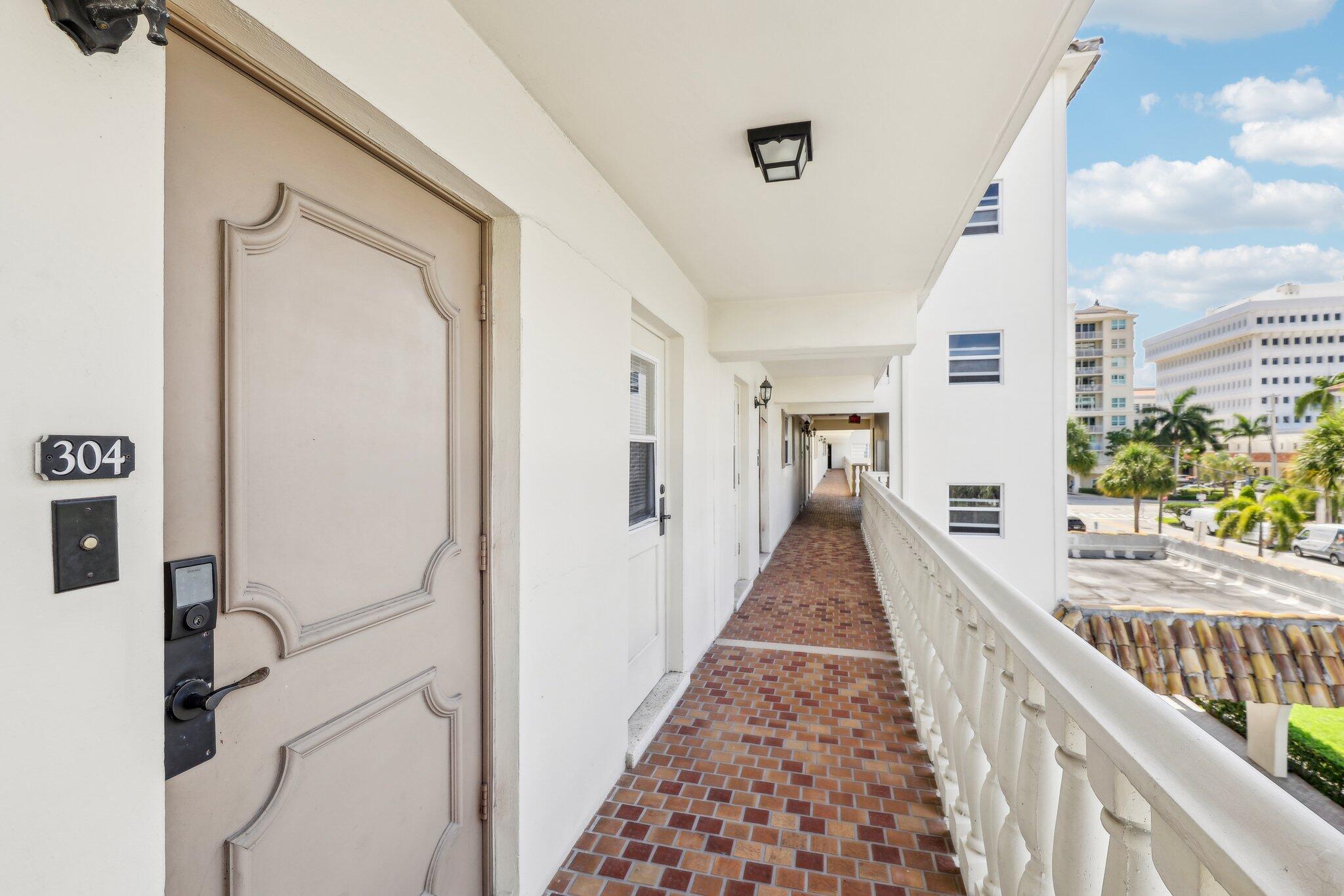 200 East Royal Palm Road, Unit 304 Boca Raton, FL 33432 - Photo 7 of 37 a view of a hallway with wooden floor and staircase