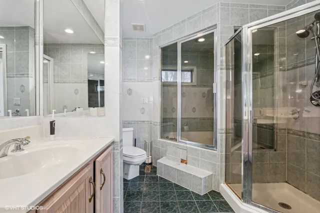 a bathroom with a sink shower and a toilet