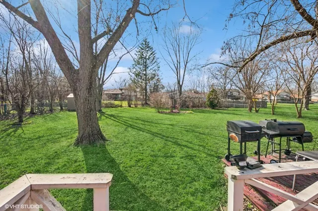 a backyard of a house with table and chairs