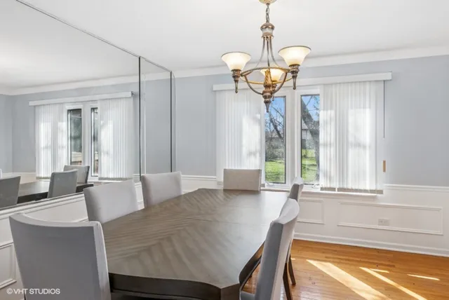 a view of a dining room with furniture wooden floor and chandelier