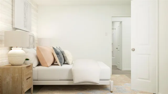 a bedroom with a bed and lamp