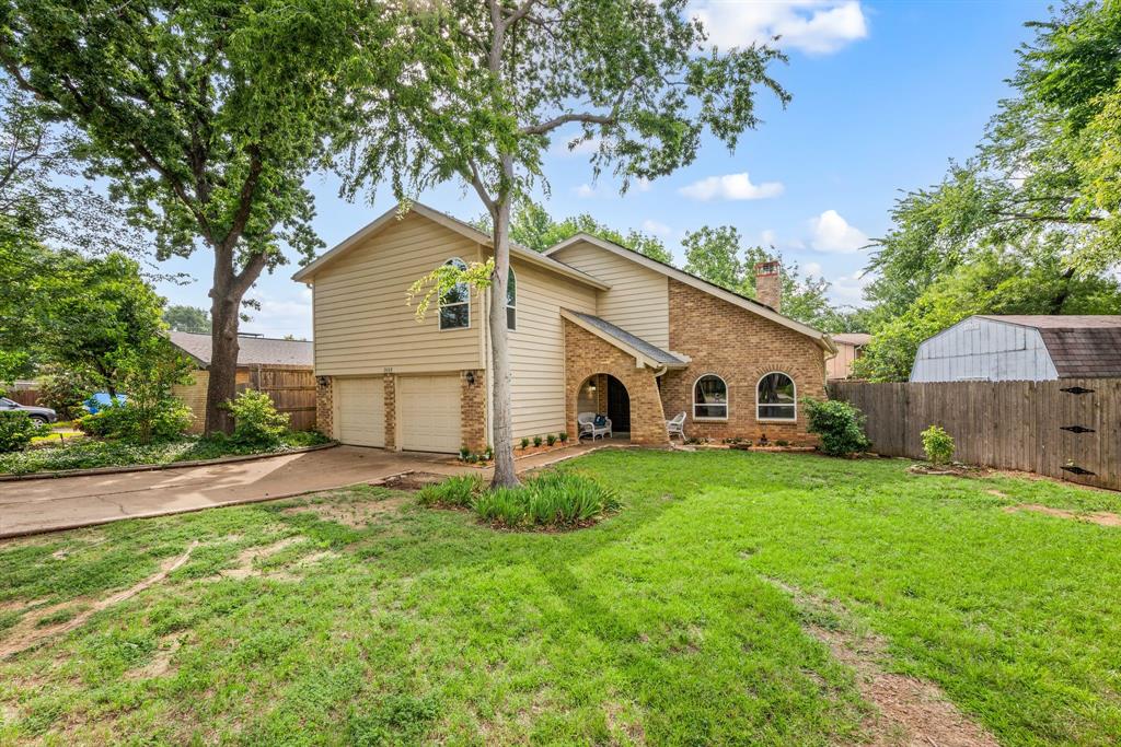 3008 Raintree Court Bedford, TX 76021 - Photo 1 of 1 View of front facade with brick siding, a garage, a chimney, and concrete driveway
