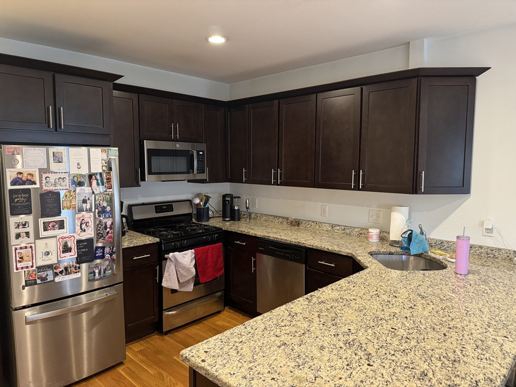 28 Howell Street, Unit 3 Boston, MA 02125 - Photo 2 of 11 a kitchen with stainless steel appliances granite countertop a sink stove and refrigerator