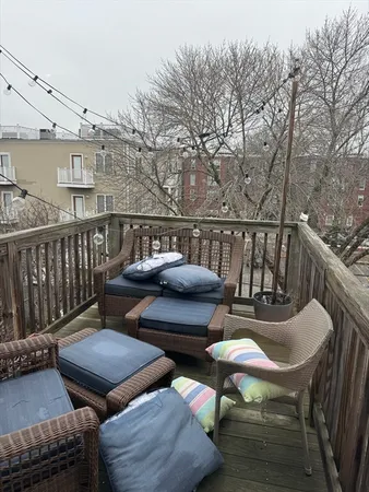 a view of a balcony with two chairs