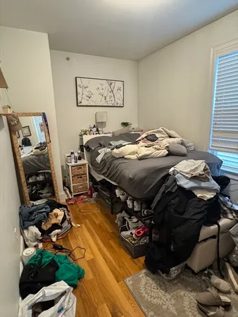 a bed sitting in a room next to a window