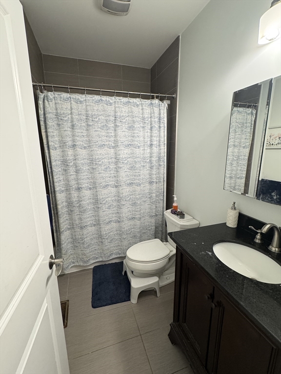 28 Howell Street, Unit 3 Boston, MA 02125 - Photo 7 of 11 a bathroom with a granite countertop sink toilet and shower