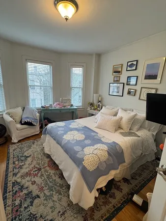 a bedroom with bed and a window