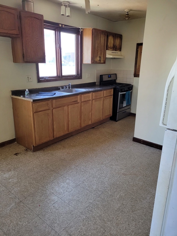 20 Sprague Street West Springfield, MA 01089 - Photo 12 of 12 a kitchen with stainless steel appliances granite countertop a stove a sink a refrigerator a microwave a sink and dishwasher