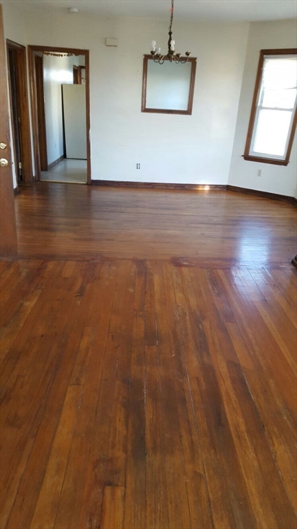 20 Sprague Street West Springfield, MA 01089 - Photo 2 of 12 an empty room with wooden floor and windows
