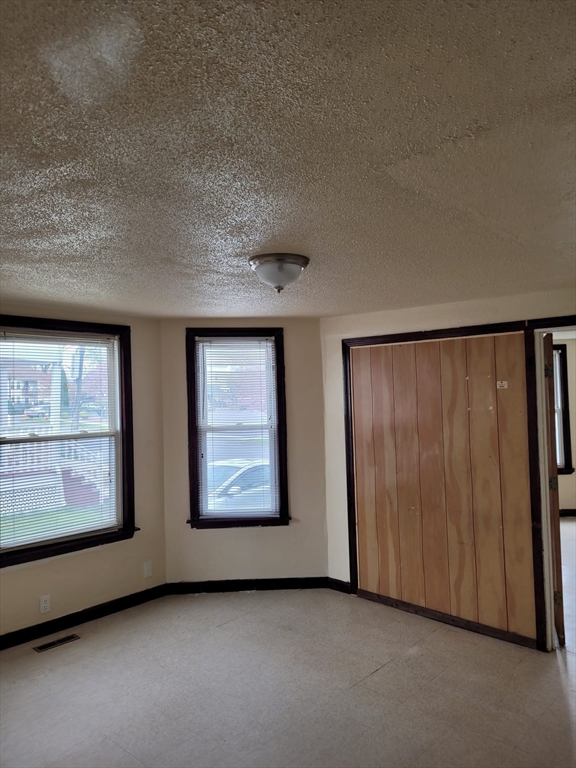 20 Sprague Street West Springfield, MA 01089 - Photo 3 of 12 an empty room with windows ceiling fan and windows