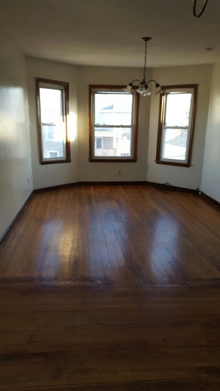20 Sprague Street West Springfield, MA 01089 - Photo 4 of 12 a view of an empty room with wooden floor and a window