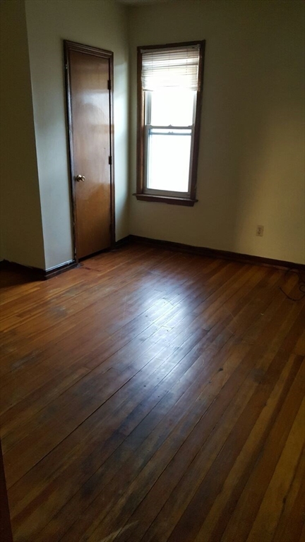20 Sprague Street West Springfield, MA 01089 - Photo 7 of 12 an empty room with wooden floor and windows