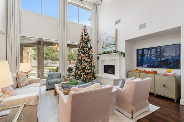 a room with pool table a flat screen tv and a bookshelf