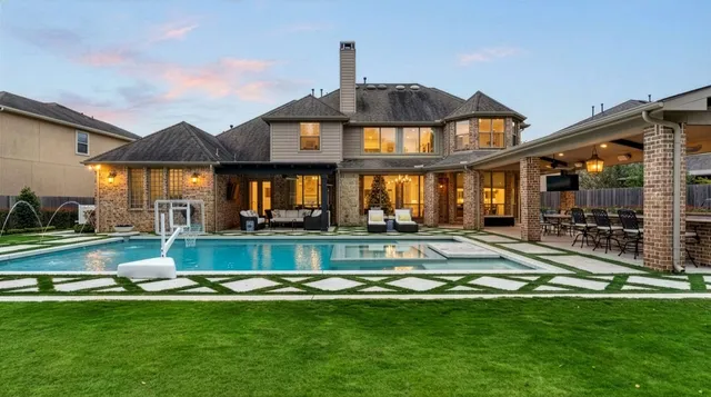 a living room with furniture a fireplace and a large window