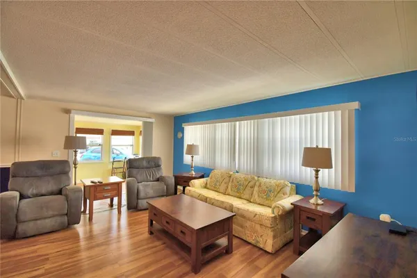 a living room with furniture and large windows