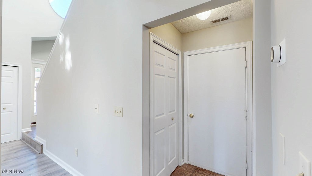 1426 Loop Road, Unit 1426 Kent, OH 44240 - Photo 13 of 40 Corridor located off the kitchen, features a closet and the door leading into the attached 2 car garage.