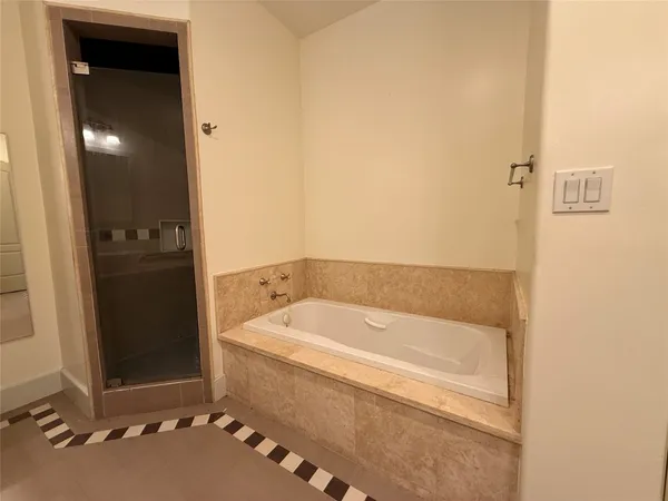 a bathroom with a bathtub and shower