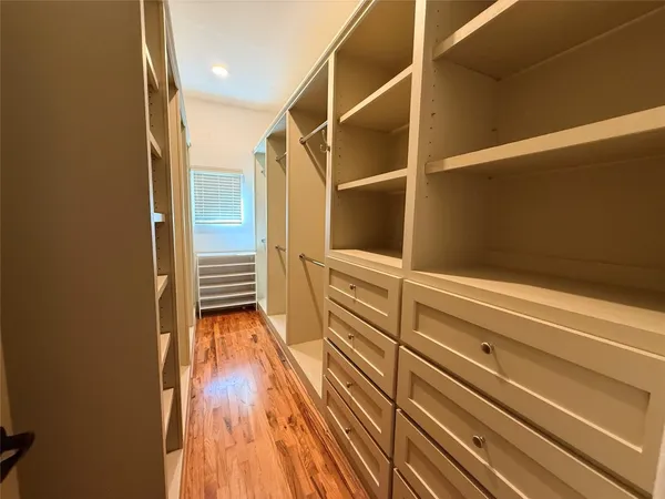 a view of closet area with wooden floor
