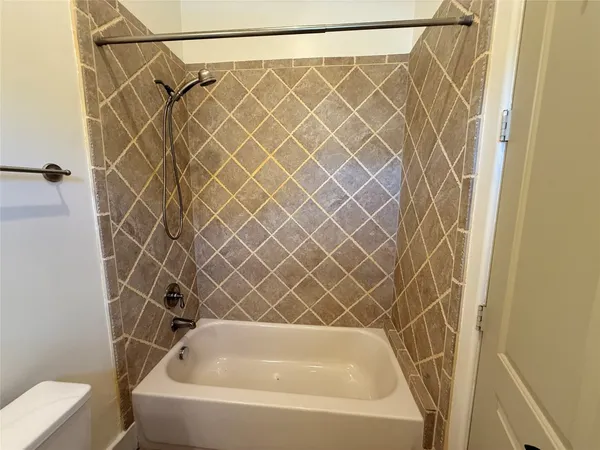 a bathroom with a bathtub and shower