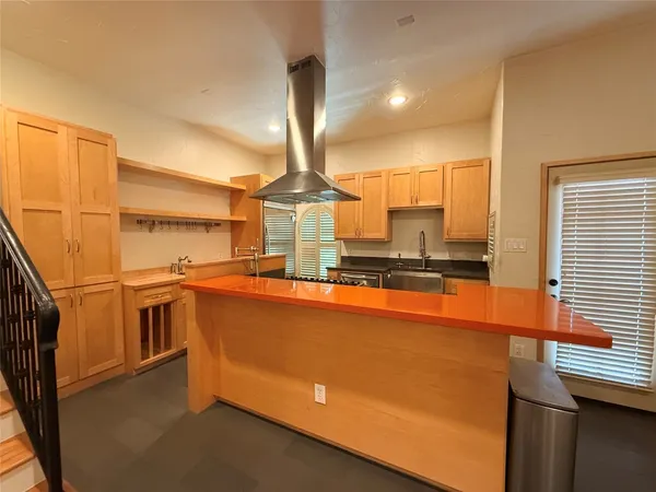 a open kitchen with stainless steel appliances granite countertop a sink a stove and a refrigerator