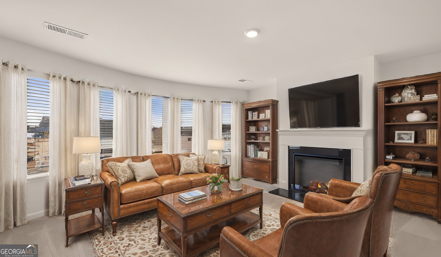 1776 Goodwin Drive Hampton, GA 30228 - Photo 13 of 59 a living room with furniture a fireplace and a flat screen tv