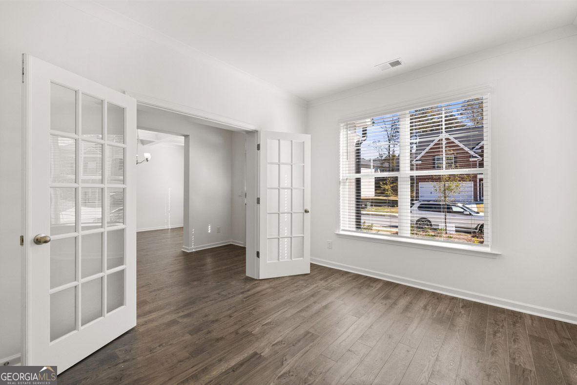 1776 Goodwin Drive Hampton, GA 30228 - Photo 42 of 59 an empty room with wooden floor and windows