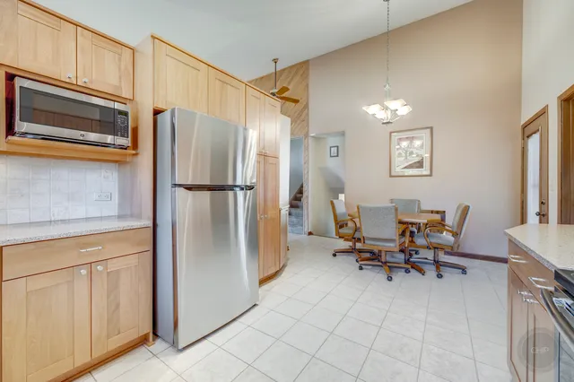 a kitchen with stainless steel appliances a refrigerator and microwave