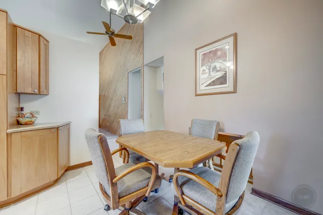 a view of a dining room with furniture and a chandelier