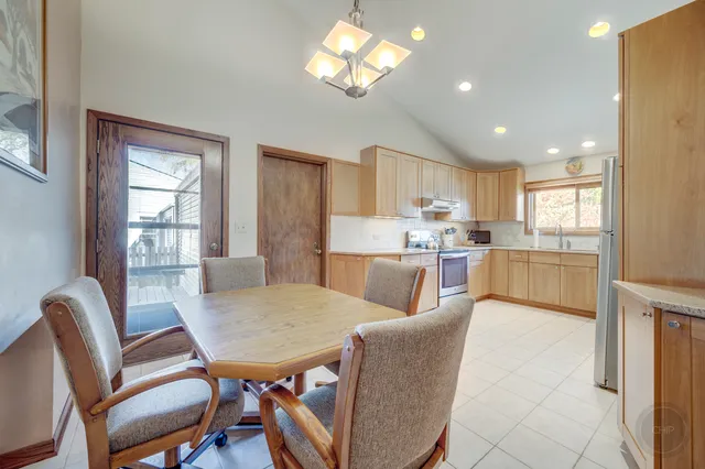 a view of a dining room with furniture and a chandelier
