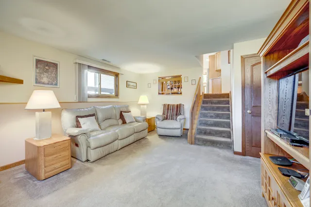 a living room with furniture a lamp and a window