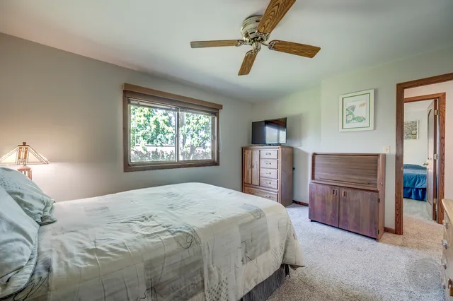 a bedroom with a bed dresser and a window